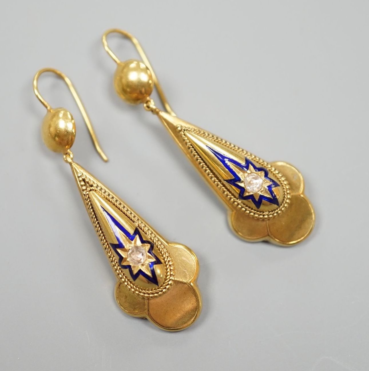 A pair of antique yellow metal, blue enamel and single stone rose cut diamond set drop earrings, overall 46mm, gross weight 7.1 grams.